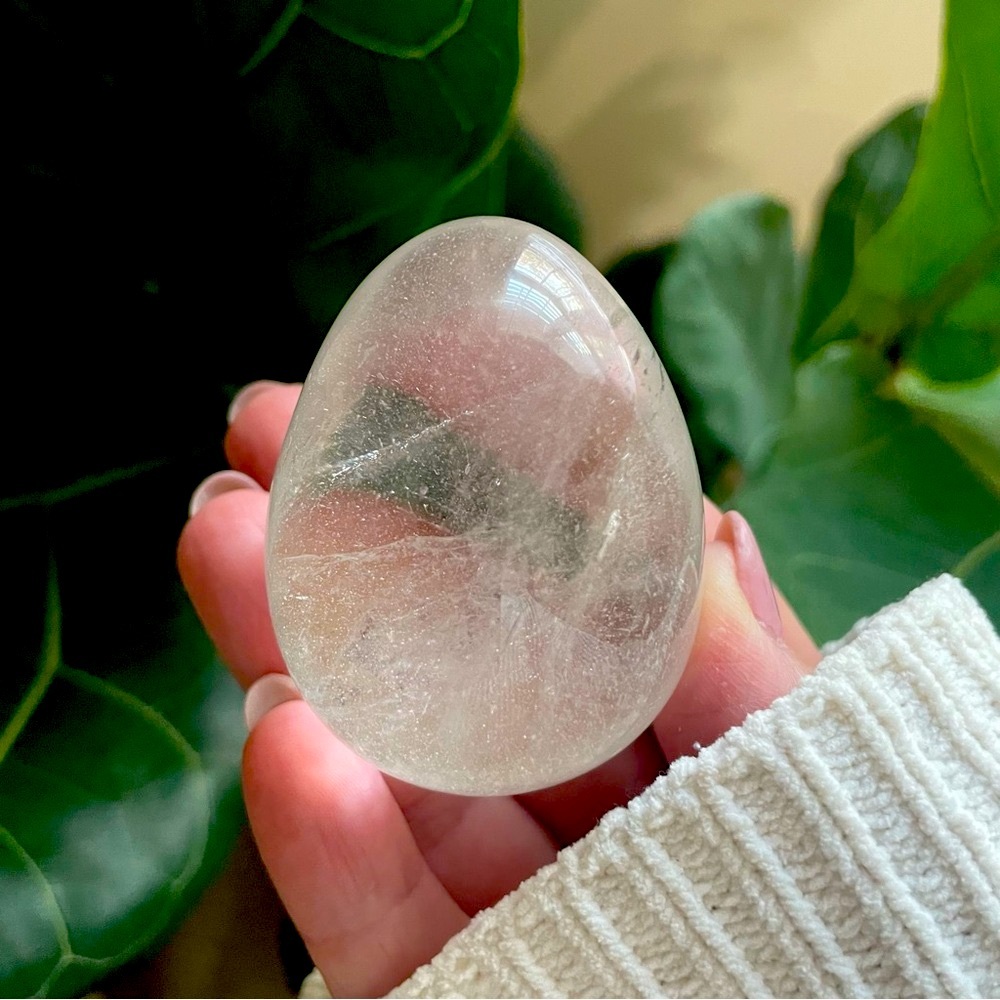 Polished clear, quartz crystal egg comes with stand. Rocks crystals minerals
